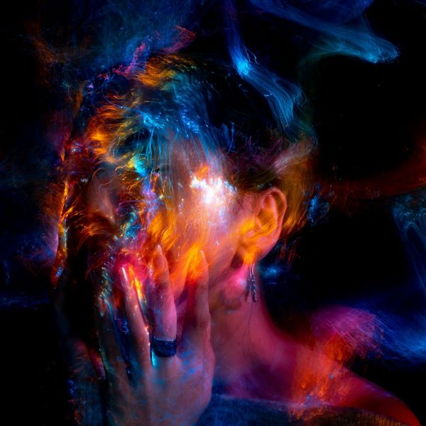 Silhouette of a person meditating with a glowing energy aura.